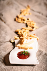 fried French fries with red sauce ketchup with linen background