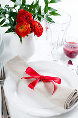 table setting with red flowers