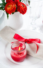 table setting with red flowers