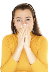 Close-up of a young woman blowing her nose