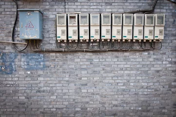 Fototapeten row of electricity meters and fuse boxes in hutong area, Beijing © Fotokon
