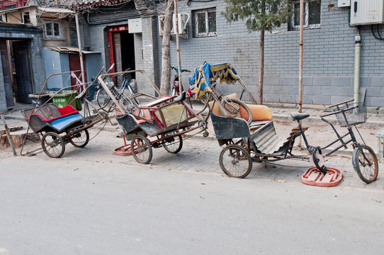 a few damged cycle rickshaws in hutong area, Beijing, China