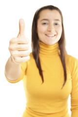Close-up of a young woman showing thumbs up