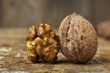 Close up of walnuts cracked open on a wooden table