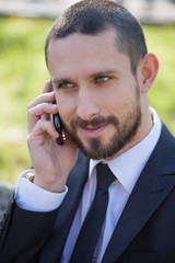Handsome young businessman with a mobile phone