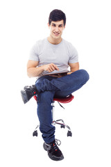 Smiling handsome latin man using a tablet computer, isolated ove