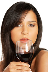 Attractive naked woman with glass of wine. Closeup.