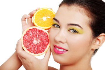 Beautiful woman's face with orange and grapefruit.