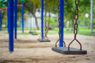 Row of chain swings on kids playground