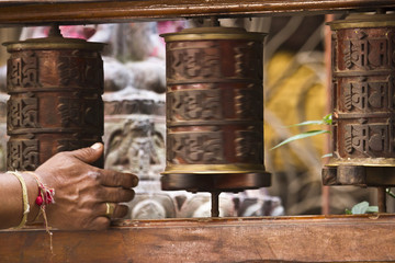 Brahman moving prayer wheel in buddhist temple