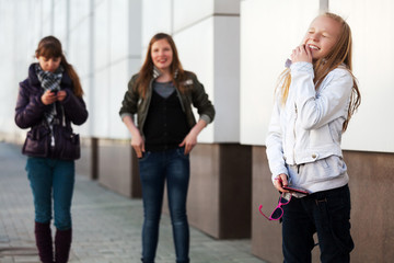 Happy teenage girls at the wall