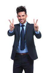smiling business man making the victory hand gesture