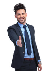 smiling business man is welcoming you with a hand shake