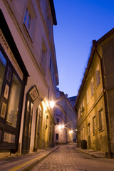 mysterious narrow alley with lanterns in Prague at night..