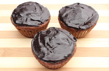 Fresh baked chocolate muffin on chopping board
