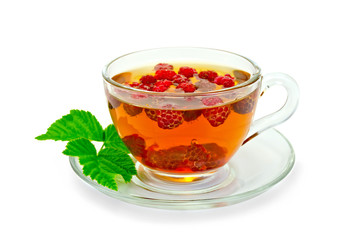Tea with raspberries and a leaf in a cup