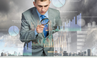 Man looking in magnifier