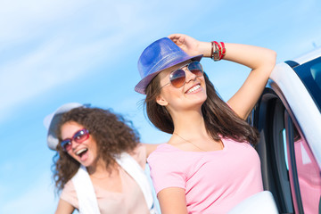 Two attractive young women wearing sunglasses