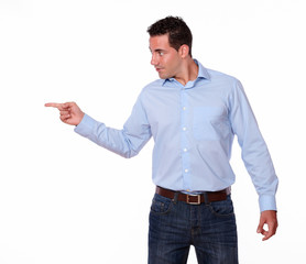 Charming young man pointing to his right