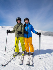 Teenage girl and boy skiing