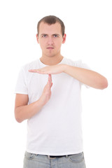 Portrait of young man gesturing time out sign isolated on white