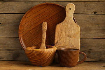 set of wooden organic utensils on natural wooden background - obrazy, fototapety, plakaty