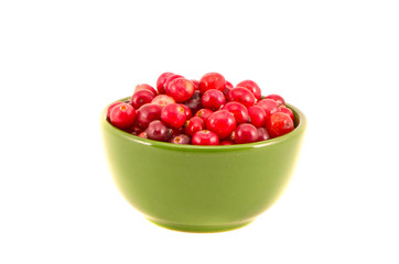 green bowl with ripe cranberries isolated on white