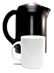 Focus on tea mug.Electric tea kettle  and mug