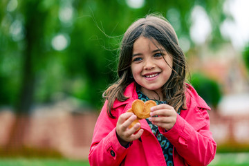 portrait of a pretty girl with cookies in the hands