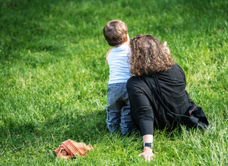 woman sitting on the grass with her son