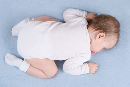 Baby Sleeps On Soft Blue Blanket. Top View