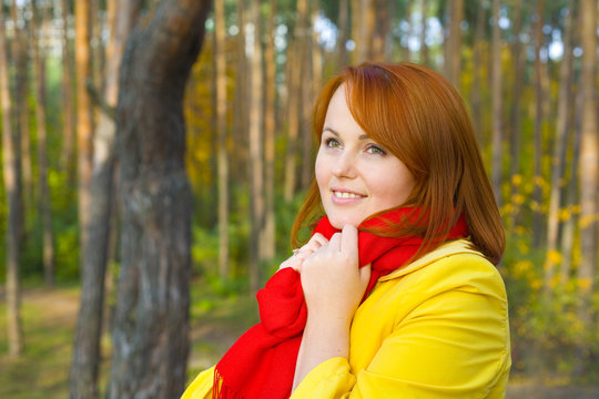 Portrait of red-haired girl outdoors