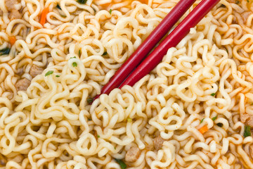 eating instant noodles by red chopsticks