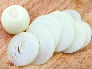 bulb and sliced onions on wooden board