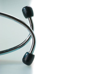 Stethoscope on blue, reflective background