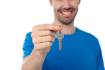 Smiling guy offering house key