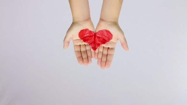showing a painted heart with hands