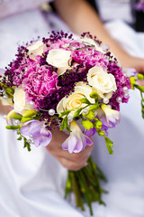 Fototapeta na wymiar Beautiful colorful wedding bouquet with bride and groom