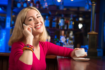 Plakat woman with a cup of coffee and cell phone