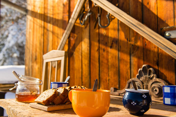 Breakfast wooden table outside winter snow cottage