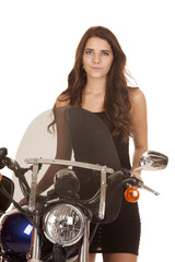 Fototapeta na wymiar Woman in black stand by motorcycle serious