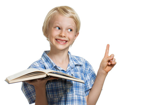 Young boy holding book and pointing