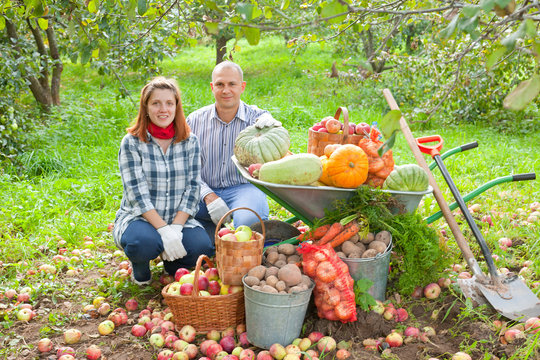 couple with  harvested vegetables