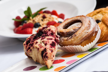Strawberries, granola, blueberries and pastries