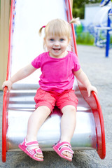 Attractive baby at a playground in the summer
