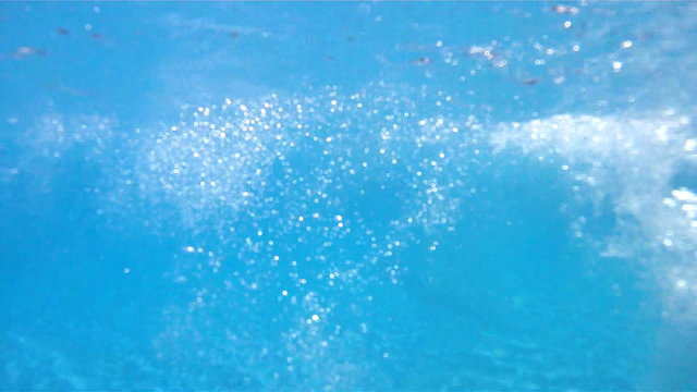 A man swimming freestyle.Camera goes underwater.