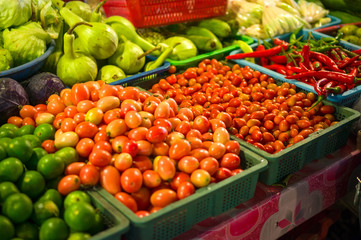 Limes, tomatoes, peppers on city market in asia