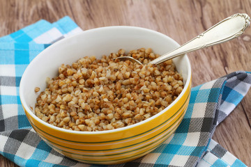 Bowl of cooked buckwheat, close up