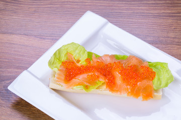 Red caviar and smoked salmon sandwich