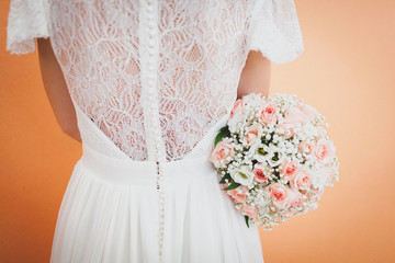 bride holding a wedding bouquet and turning back to the camera